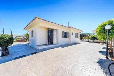a villa with a driveway and a house at Villa Marizan in Protaras