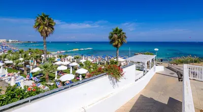 a view of the beach from the balcony of a resort at Villa Marizan in Protaras
