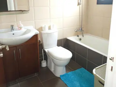 a bathroom with a toilet and a sink and a tub at Villa Chrysa in Protaras