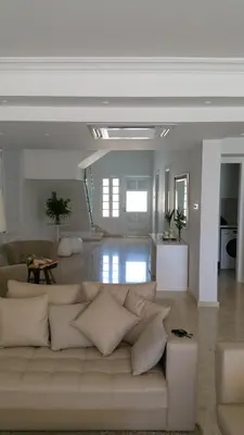 a living room with a white couch in a room at Serenity Villa Mediterranean in Pervolia