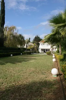 a yard with white balls on the grass at Serenity Villa Mediterranean in Pervolia