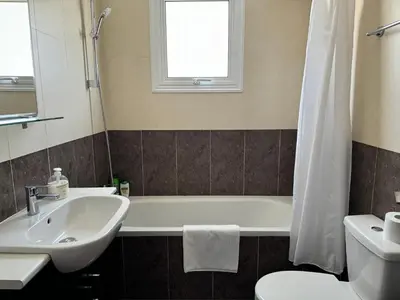 a bathroom with a sink and a tub and a toilet at Apartment at luxurious Mythical Sands Resort in Paralimni