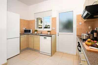 a kitchen with white appliances and a counter top at Villa Summer in Protaras