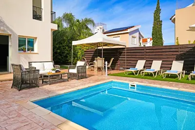 a swimming pool in the backyard of a house at Villa Summer in Protaras