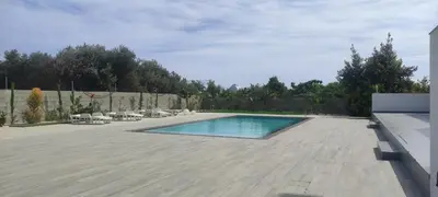 a swimming pool in a yard with chairs and a fence at Kiti Village Villa, Cyprus, salt-water pool, 5 bedrooms, Larnaca in Kiti