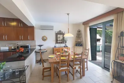 a kitchen and dining room with a table and chairs at Spetses Villa 5 in Protaras