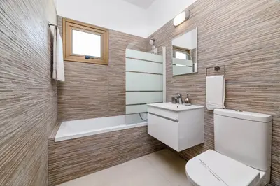 a bathroom with a toilet and a sink and a mirror at Kymma Villa #16 in Ayia Napa