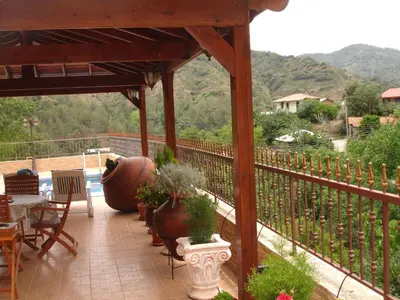 a gazebo with a table and chairs and plants at The Love Holiday House in Tris Elies