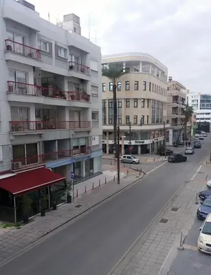 an empty street in a city with buildings at Markora Central Apartment in Nicosia