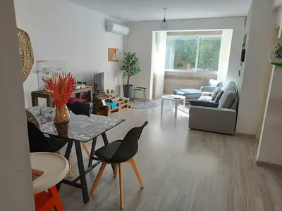 a living room with a table and chairs at Markora Central Apartment in Nicosia