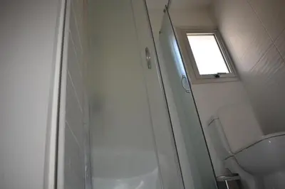 a bathroom with a shower and a toilet and a window at P L PANAGIOTIS Apartment in Larnaka