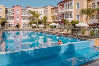 a woman sitting in a swimming pool at a hotel at Louis Althea Beach in Protaras
