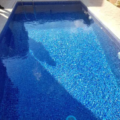 a large blue swimming pool with blue water at Marias Villa in Protaras