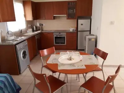 a kitchen with a table and chairs in a kitchen at Marias Villa in Protaras