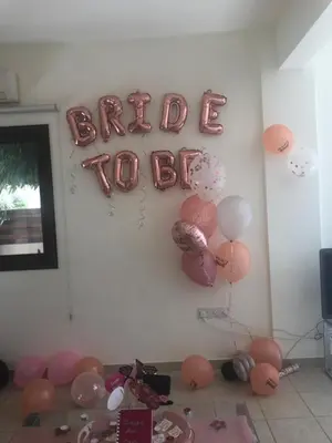 a wall with balloons and a sign that says back to back at Marias Villa in Protaras