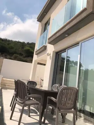 a patio with a table and chairs on a balcony at Villa Spathele in Paralimni