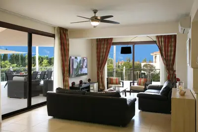 a living room with couches and a large glass door at Villa Leonidas in Protaras