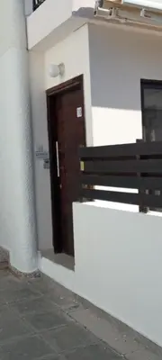 a door to a building with a bench in front of it at George Apartments in Ayia Napa