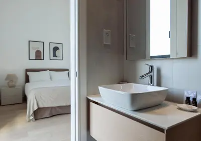 a bathroom with a sink and a bed at Nicosia Central Park Residences in Nicosia