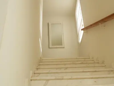 a staircase in a white room with a mirror at Villas Ithaca Protaras in Protaras