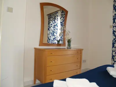 a bedroom with a dresser with a mirror on it at Villas Ithaca Protaras in Protaras