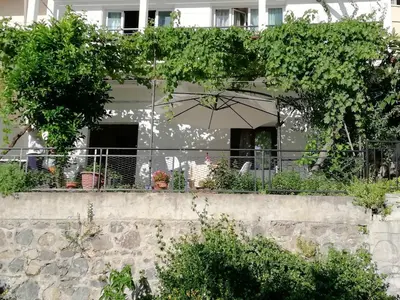 a house with an umbrella on a wall at Christos House in Kakopetria