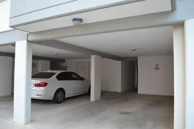 a white car parked inside of a garage at Alania Sea View Apartment in Limassol