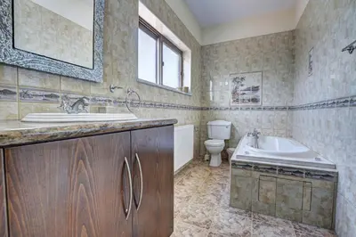 a bathroom with a sink and a tub and a toilet at Villa Eva in Ayia Napa