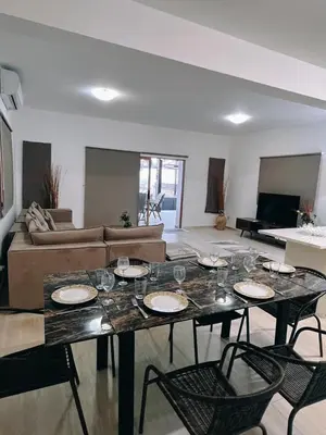 a living room with a table with glasses on it at Oasi Rejuve Villa in Meneou