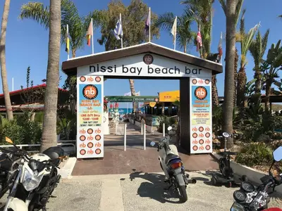 a kiosk with motorcycles parked in front of a beach bar at Luxury Apartment Ayia Napa Center in Ayia Napa