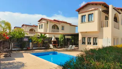 a house with a swimming pool in front of it at Cy-Blue in Protaras