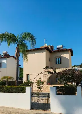 a house with a gate and a palm tree at Cy-Blue in Protaras