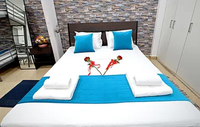 a large bed with two red roses on it at Pieris Apartments in Ayia Napa