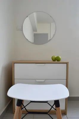 a white table with a mirror on a wall at Athena Holiday Homes in Limassol