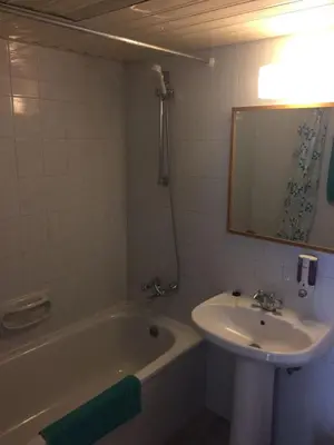 a bathroom with a sink and a tub and a mirror at Nautilus Tourist Apartments in Larnaka