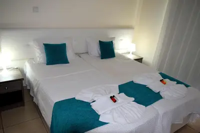 a hotel room with two beds with towels on them at Cross Road in Ayia Napa