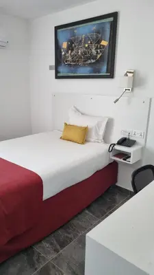 a bedroom with a bed and a picture on the wall at Art & Wine Boutique Hotel in Larnaka