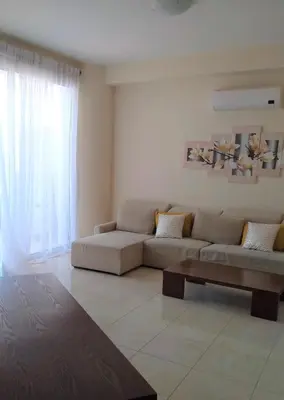 a living room with a couch and a coffee table at T&E Apartment in Larnaka