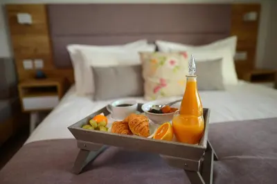 a tray of food with a bottle of orange juice at Hypnos Boutique Hotel in Nicosia