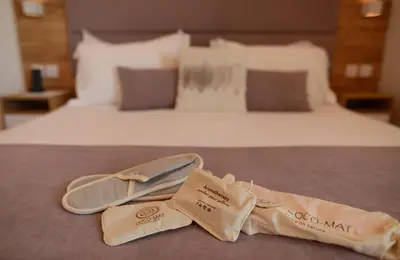 a pair of shoes sitting on top of a bed at Hypnos Boutique Hotel in Nicosia