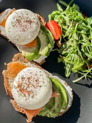 a sandwich with eggs and a salad on a plate at Hypnos Boutique Hotel in Nicosia
