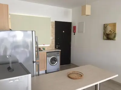 a kitchen with a refrigerator and a washing machine at Great Kings Resort Apartment 10 Block 19 in Protaras