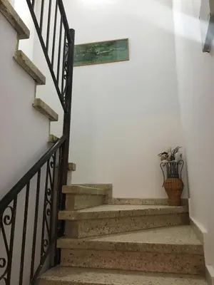 a stairway with a vase on the wall at Xenios Guesthouse in Koilani