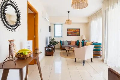 a living room with a table and a couch at CityDen in Larnaka