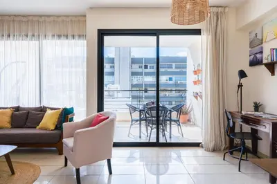 a living room with a couch and a table at CityDen in Larnaka