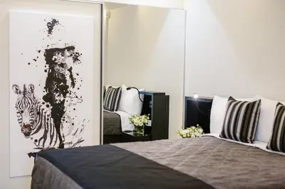 a bedroom with a zebra painting on the wall at Qbic City Hotel in Larnaka