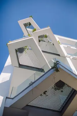a building with three windows with plants on it at Qbic City Hotel in Larnaka