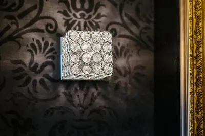 a box on the wall of a room with a wallpaper at Qbic City Hotel in Larnaka