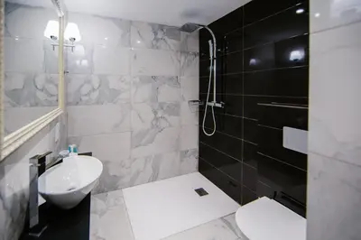 a bathroom with a sink and a toilet and a shower at Qbic City Hotel in Larnaka