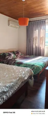 a bedroom with two beds and a window at Siamese Villa in Paralimni